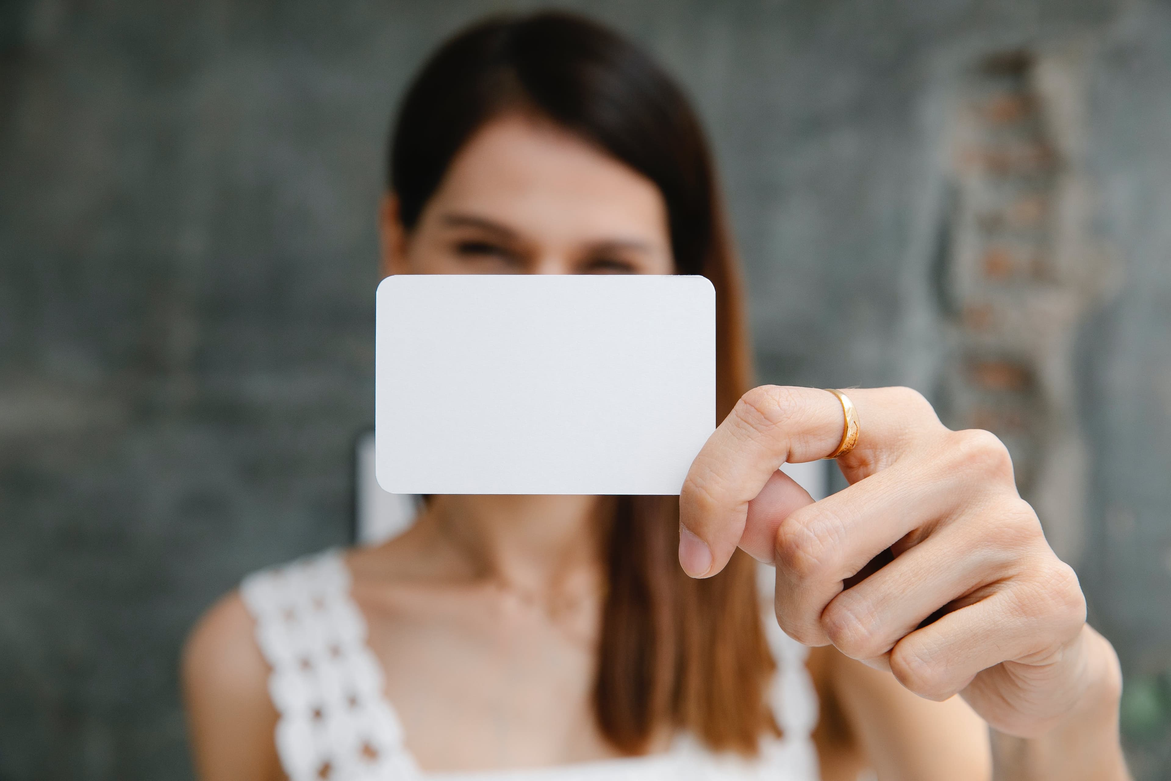 A girl holding a visiting card